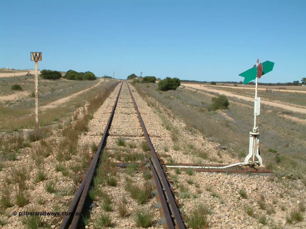 030411 141801
Nunjikompita, looking east from the east end of the yard, W whistle or horn post for grade crossing of Nunyah Road in the distance.
