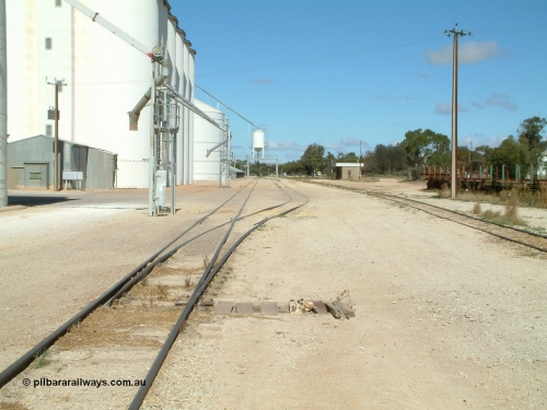 030411 110106
Kimba, station yard view looking south, point level is covered to allow road vehicles to travel over it as a tractor is sometimes used for shunting. The loadout spouts are evident along with the Ascom loadout silo and horizontal bunker beyond that.
