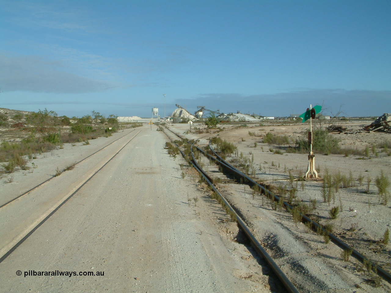 030414 163944
Kevin, looking south at the gypsum plant, the triangle can be seen branching off on the right, loop on the left, the mainline to Penong continues on behind the camera.
