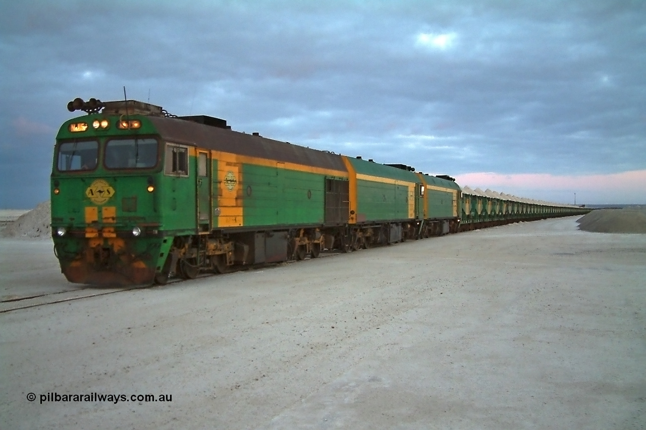 030415 065601
Kevin, loading is almost complete 0700 hrs. as gypsum train 3DD2 stands behind triple NJ class Clyde Engineering EMD JL22C model units NJ 5 serial 71-732, NJ 6 serial 71-733 and NJ 3 serial 71-730, these units built in 1971 at Clyde's Granville workshops started out on the Central Australia Railway for the Commonwealth Railways before being transferred to the Eyre Peninsula system in 1981. At the [url=https://goo.gl/maps/fjUHW]Kevin loading point[/url].
Keywords: NJ-class;NJ5;Clyde-Engineering-Granville-NSW;EMD;JL22C;71-732;