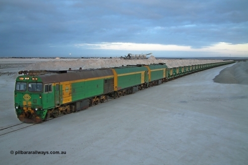 030415 070408
Kevin, loading is almost complete 0700 hrs. as gypsum train 3DD2 stands behind triple NJ class Clyde Engineering EMD JL22C model units serial 71-732, NJ 6 serial 71-733 and NJ 3 serial 71-730, these units built in 1971 at Clyde's Granville workshops started out on the Central Australia Railway for the Commonwealth Railways before being transferred to the Eyre Peninsula system in 1981. In the background are the old loading bins. At the [url=https://goo.gl/maps/fjUHW]Kevin loading point[/url].
Keywords: NJ-class;NJ5;Clyde-Engineering-Granville-NSW;EMD;JL22C;71-732;