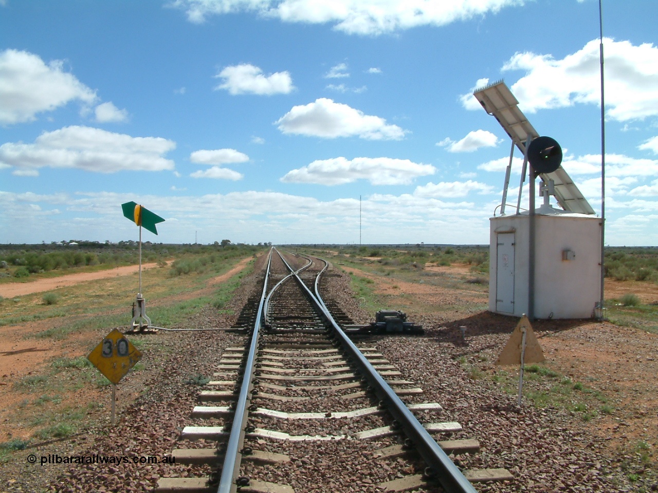 030415 135207
Kingoonya, located at the 426.5 km looking west along the Trans Australian Railway shows 1800 metre long loop on the right, 30 km/h speed restriction and interlocking hut, the town is located over on the left. [url=https://goo.gl/maps/7TMcikXj33EqWvyCA]GeoData location[/url].
