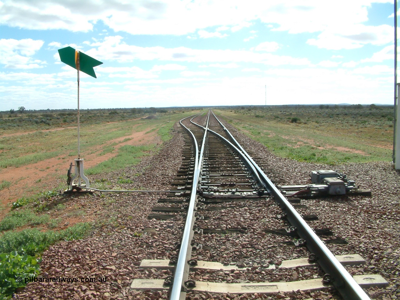 030415 145938
Ferguson, located at the 469 km on the Trans Australian Railway, looking west at the east end of the 1800 metre long crossing loop, point work on timber sleepers, indicator and lever with dual control point machine on the right. [url=https://goo.gl/maps/XNaMGCNxZ4yv7Lrr9]GeoData location[/url].
