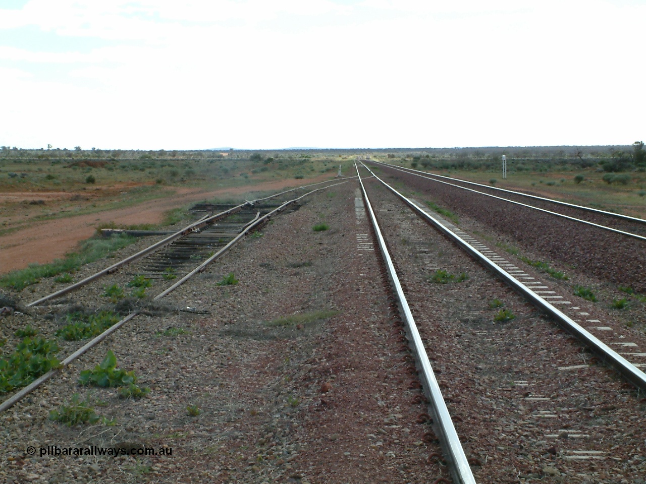 030415 150437
Ferguson, located at the 469 km on the Trans Australian Railway, looking west along the 1800 metre long crossing loop, siding point work on timber sleepers for west end of goods siding with the remains of another set of points. [url=https://goo.gl/maps/XNaMGCNxZ4yv7Lrr9]GeoData location[/url].
