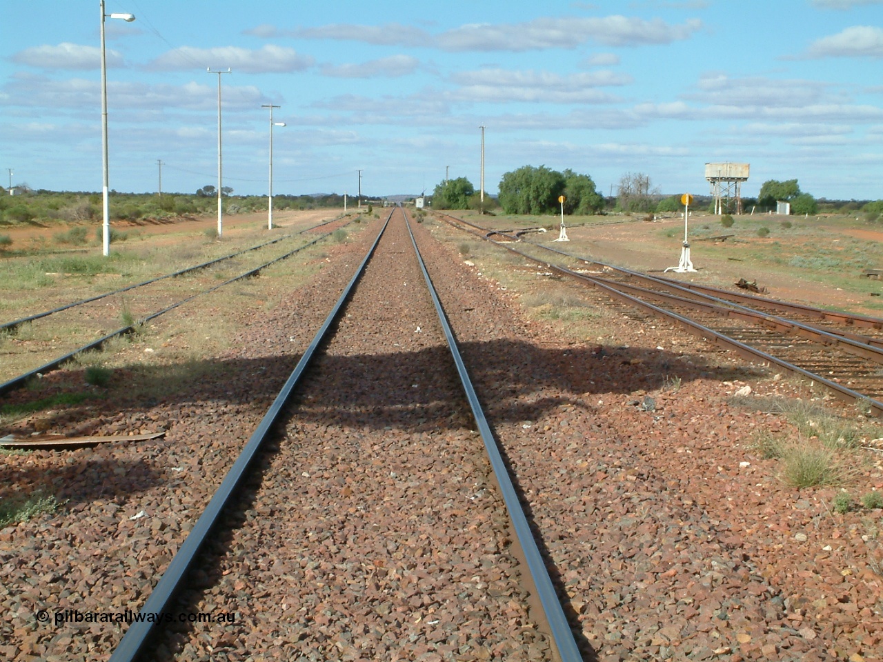 030415 154424
Tarcoola, at the 504.5 km, looking east along the Trans Australian Railway in the middle of the yard, the Central Australian Railway is on the left, loop on the right, east leg of triangle is just in view with the sidings running east behind the large tree and water tank. Tarcoola is the junction for the TAR and CAR railways situated 504 km from the 0 km datum at Coonamia. [url=https://goo.gl/maps/cWayk3LD2QQjX6Z88]GeoData location[/url]. 15th April 2003.
