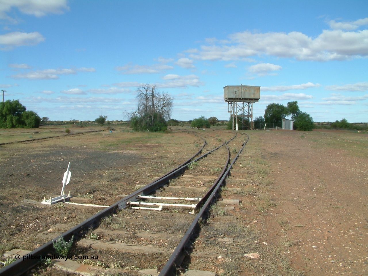 030415 154820
Tarcoola, at the 504.5 km, looking south east along the No. 1 Water Road, set of points is the No. 2 Loco Road, No. 1 Loco and Camp Train roads are visible to the left. Water tank on stand. [url=https://goo.gl/maps/AhdgsdPfRS8cXWMP8]GeoData location[/url]. 15th April 2003.
