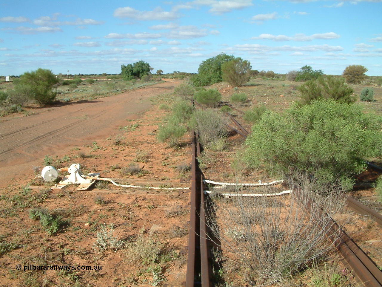 030415 155228
Tarcoola, at the 504.5 km, looking east, points for Camp Train and No. 2 Loco Roads with the No. 1 Water Road coming in from the right. Mainline to the left. [url=https://goo.gl/maps/y17pUsTYVeRwPsa67]GeoData location[/url]. 15th April 2003.
