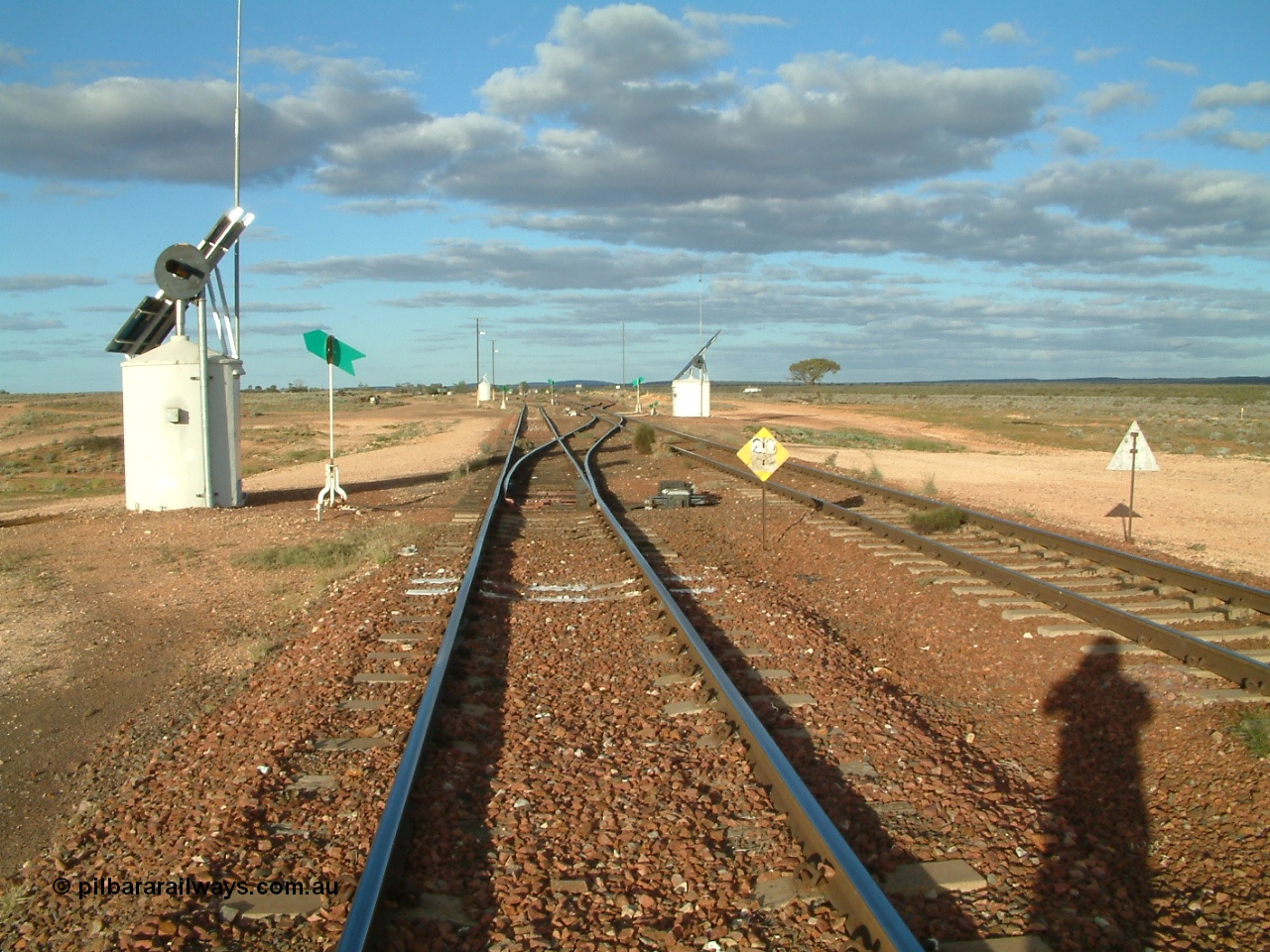 030415 171358
Tarcoola, at the 504.5 km, looking east along the Central Australia line at the western end of the loop and Trans Australian is the right road. Tarcoola is the junction for the TAR and CAR railways situated 504 km from the 0 km datum at Coonamia. 15th April 2003.
