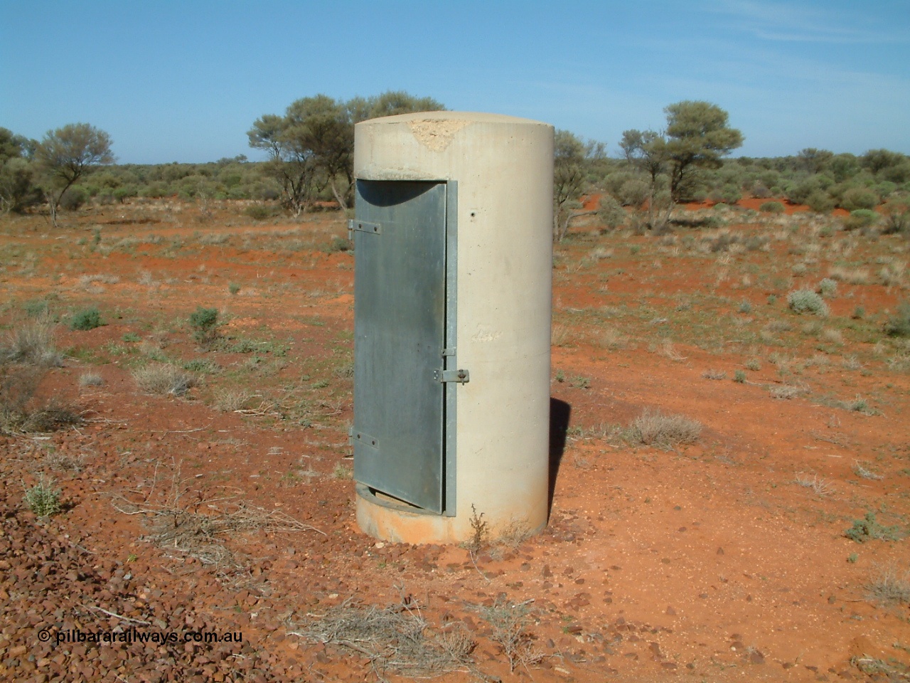 030416 094500
Wirrida Siding, train control phone booth 'pillbox'. Located at the 641 km from the 0 datum at Coonamia and 137 km north of Tarcoola between Carnes and Manguri on the Tarcoola - Alice Springs line. [url=https://goo.gl/maps/eznFBHok5p6yPEcq6]GeoData location[/url]. 16th April 2003.
