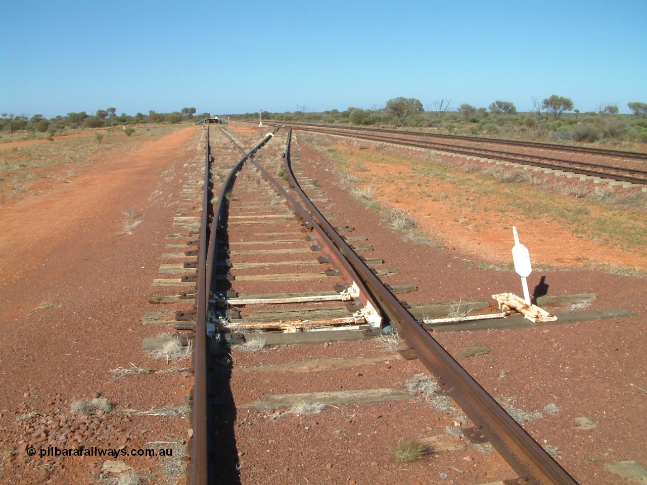 030416 094958
Wirrida Siding, looking south towards Tarcoola with the goods loop returning to the loop and the loading ramp and siding points. Located at the 641 km from the 0 datum at Coonamia and 137 km north of Tarcoola between Carnes and Manguri on the Tarcoola - Alice Springs line. [url=https://goo.gl/maps/CNUy7icETwEEQPgq7]GeoData location[/url]. 16th April 2003.
