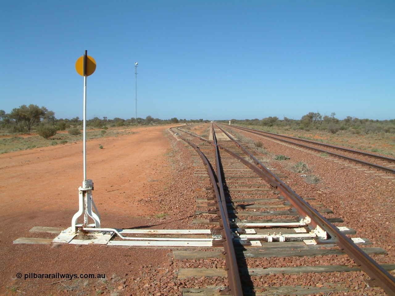 030416 095258
Wirrida Siding, looking south towards Tarcoola with the goods siding and points rejoining the loop, notice the points are on timber sleepers while the loop and mainlines are on concrete, train control 'pillbox' in the distance. Located at the 641 km from the 0 datum at Coonamia and 137 km north of Tarcoola between Carnes and Manguri on the Tarcoola - Alice Springs line. [url=https://goo.gl/maps/kr4tGiBQqpQpopy56]GeoData location[/url]. 16th April 2003.
