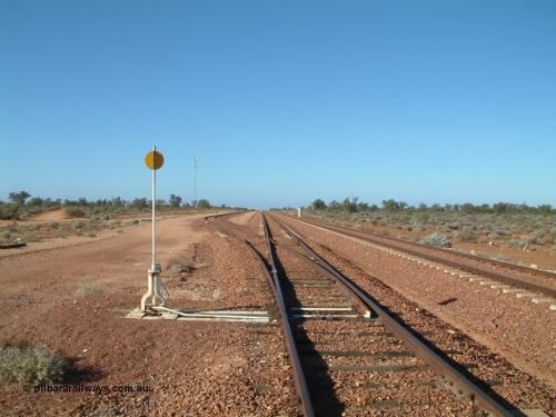030416 084242
Carnes Siding located at the 566.4 km on the Central Australian line from Tarcoola to Alice Springs. View looking south from the north end of the goods siding rejoining the loop and the mainline at right. The train control 'pillbox' concrete hut is visible with the station nameboard the white item beside it. [url=https://goo.gl/maps/QbycvbbHxJHLg8h87]GeoData location[/url]. 1April 6, 2003.
