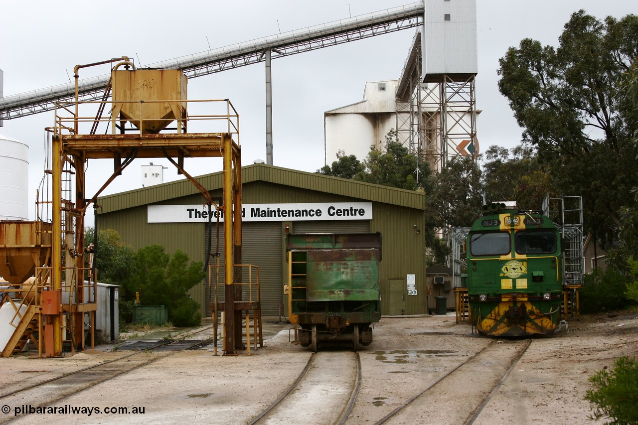 051102 6615
Thevenard Maintenance Centre overview, with NJ class Clyde Engineering EMD JL22C model unit NJ 3 serial 71-730, built in 1971 at Clyde's Granville NSW workshops, started out on the Central Australia Railway for the Commonwealth Railways before being transferred to the Eyre Peninsula system in 1981. Still in AN green but lettered for Australian Southern Railroad and a lone ENH type hopper standing around 'on-shed'. Behind the sanding plant and shed are the no longer rail serviced grain silos.
Keywords: NJ-class;NJ3;Clyde-Engineering-Granville-NSW;EMD;JL22C;71-730;