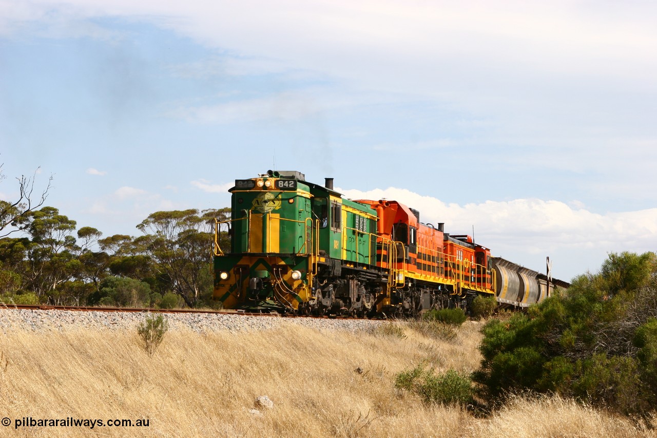 060109 2104
Kyancutta, Kyancutta Tanks Rd grade crossing, ASR 830 class unit 842, an AE Goodwin built ALCo DL531 model loco serial 84140 leads EMD unit 1204 due to air-conditioning trouble and sister ALCo 851 lift the empty north bound grain train away from crew change. 9th January 2006.
Keywords: 830-class;842;84140;AE-Goodwin;ALCo;DL531;