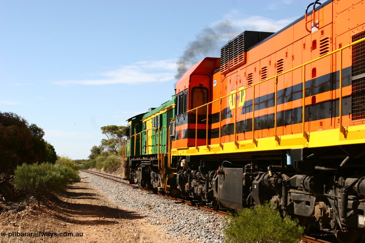 060109 2108
Kyancutta, Kyancutta Tanks Rd grade crossing, ASR 830 class unit 842, an AE Goodwin built ALCo DL531 model loco serial 84140 leads EMD unit 1204 due to air-conditioning trouble and sister ALCo 851 lift the empty north bound grain train away from crew change. 9th January 2006.
Keywords: 1200-class;1204;Clyde-Engineering-Granville-NSW;EMD;G12C;65-428;A-class;A1514;