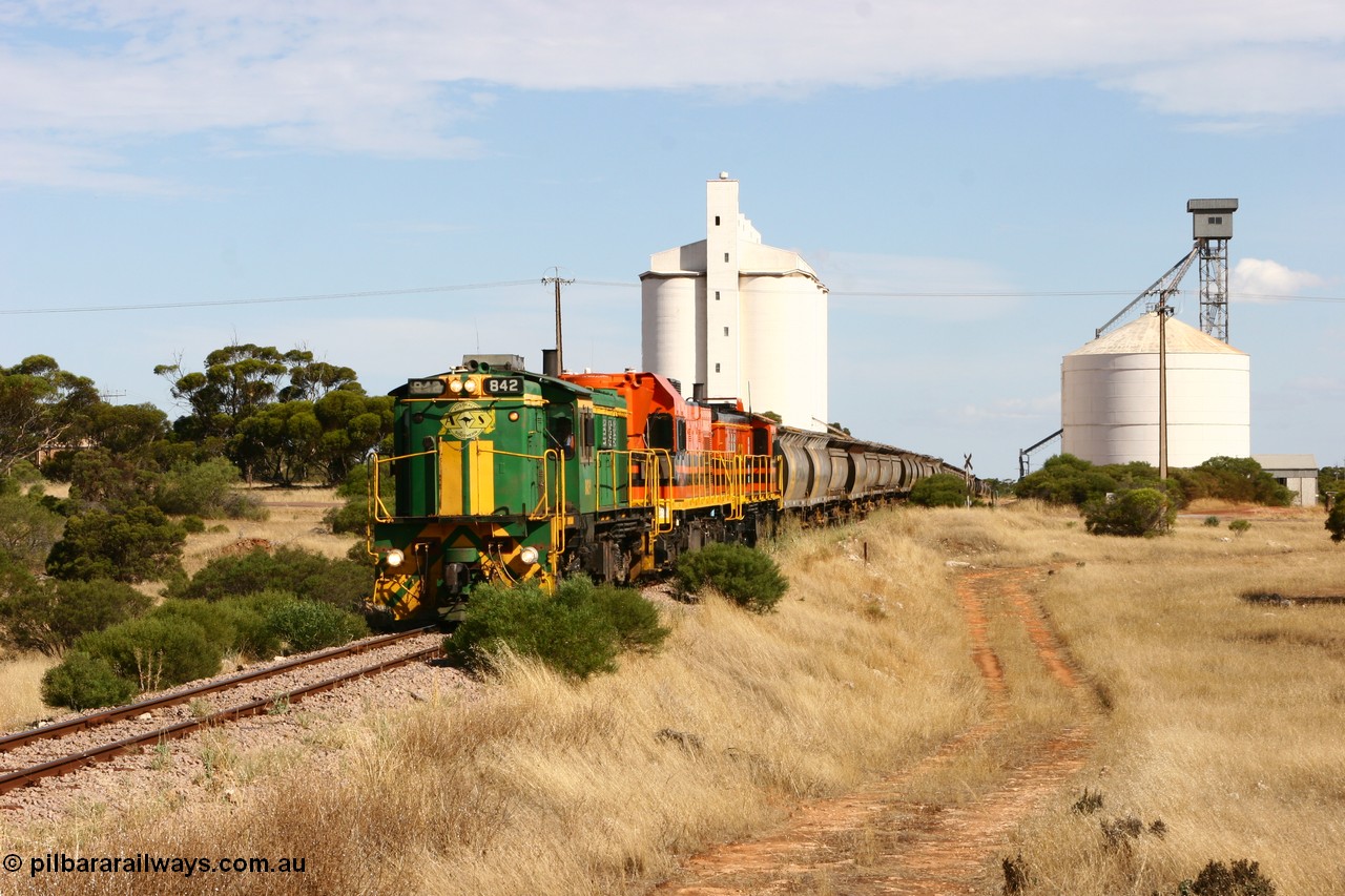 060109 2112
Kyancutta, ASR 830 class unit 842, an AE Goodwin built ALCo DL531 model loco serial 84140 leads EMD unit 1204 due to air-conditioning trouble and sister ALCo 851 as they shunt across Museum Terrace to place empty grain waggons on the silo loop. 9th January 2006.
Keywords: 830-class;842;AE-Goodwin;ALCo;DL531;84140;