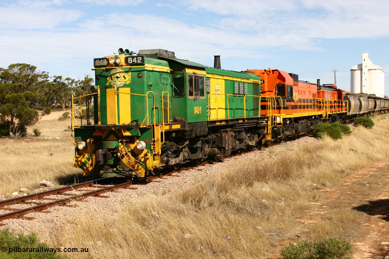 060109 2114
Kyancutta, ASR 830 class unit 842, an AE Goodwin built ALCo DL531 model loco serial 84140 leads EMD unit 1204 due to air-conditioning trouble and sister ALCo 851 as they shunt across Museum Terrace to place empty grain waggons on the silo loop. 9th January 2006.
Keywords: 830-class;842;AE-Goodwin;ALCo;DL531;84140;