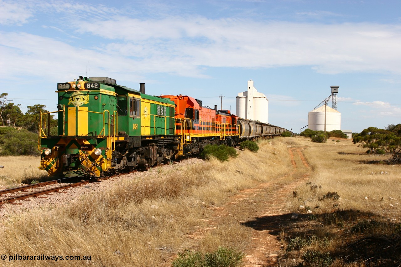 060109 2117
Kyancutta, ASR 830 class unit 842, an AE Goodwin built ALCo DL531 model loco serial 84140 leads EMD unit 1204 due to air-conditioning trouble and sister ALCo 851 as they shunt across Museum Terrace to place empty grain waggons on the silo loop. 9th January 2006.
Keywords: 830-class;842;AE-Goodwin;ALCo;DL531;84140;