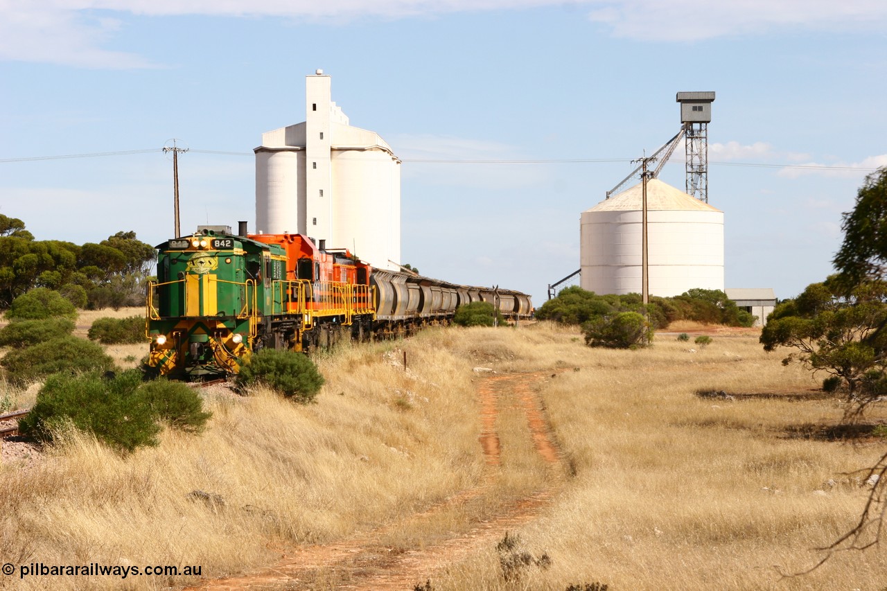 060109 2118
Kyancutta, ASR 830 class unit 842, an AE Goodwin built ALCo DL531 model loco serial 84140 leads EMD unit 1204 due to air-conditioning trouble and sister ALCo 851 as they shunt across Museum Terrace to place empty grain waggons on the silo loop. 9th January 2006.
Keywords: 830-class;842;84140;AE-Goodwin;ALCo;DL531;