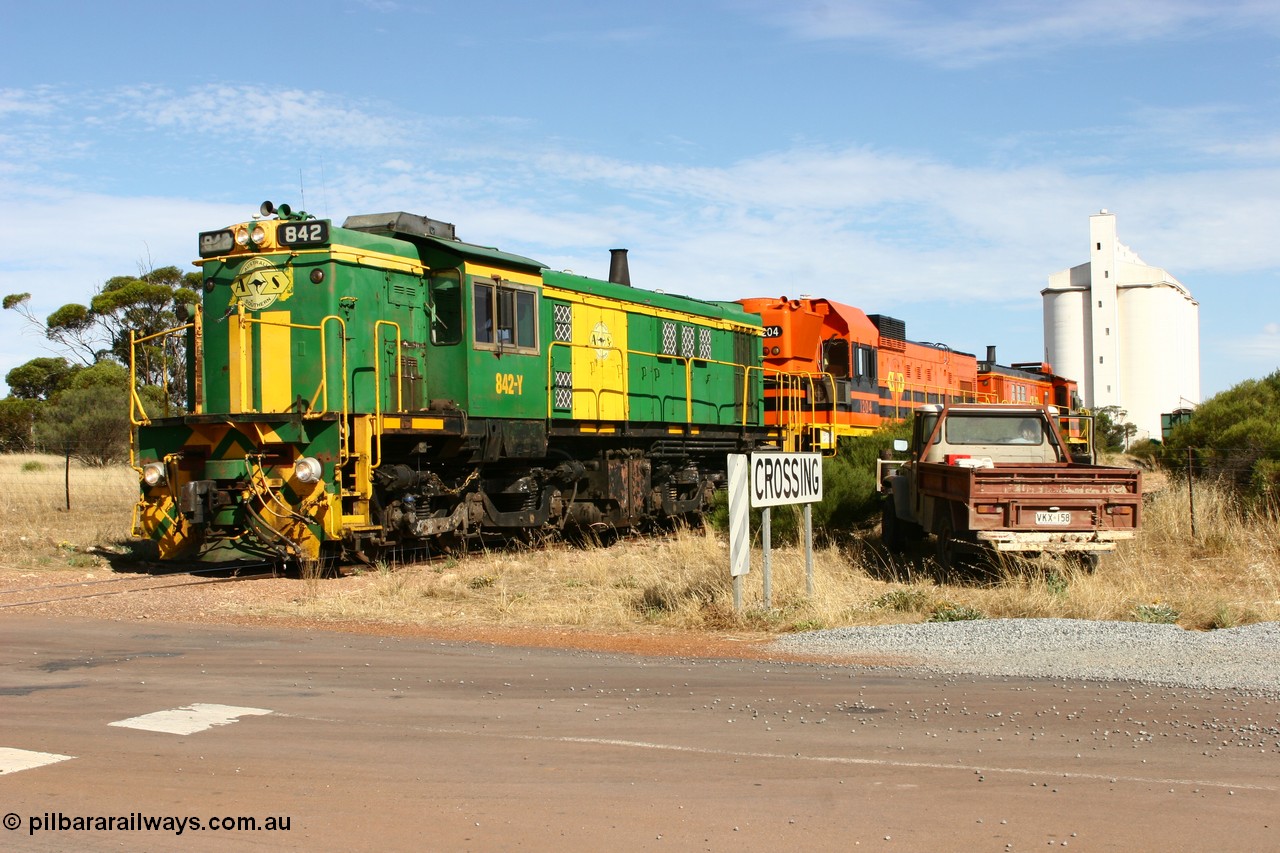 060109 2130
Kyancutta, ASR 830 class unit 842, an AE Goodwin built ALCo DL531 model loco serial 84140 leads EMD unit 1204 due to air-conditioning trouble and sister ALCo 851 as they shunt across Museum Terrace to re-join the train on the mainline. 9th January 2006.
Keywords: 830-class;842;84140;AE-Goodwin;ALCo;DL531;