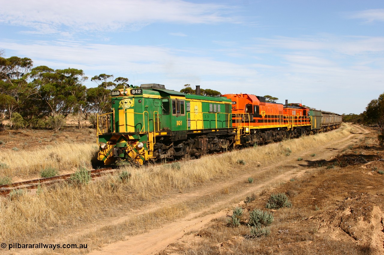 060109 2142
Wannamana, [url=https://goo.gl/maps/43EOs]on the curve[/url] 2 km north of the former station site empty train lead by ASR 830 class unit 842, an AE Goodwin built ALCo DL531 model loco serial 84140 with an EMD 1200 class and a sister ALCo unit. 9th January 2006.
Keywords: 830-class;842;84140;AE-Goodwin;ALCo;DL531;