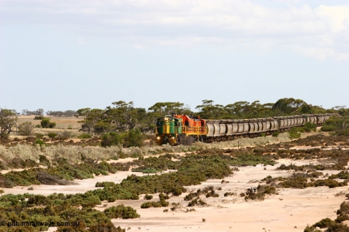 060109 2090
Kyancutta at the 198 km, ASR 830 class unit 842, an AE Goodwin built ALCo DL531 model loco serial 84140 leads EMD unit 1204 due to air-conditioning trouble and sister ALCo 851 across a dry salt soak with a north bound empty grain train. January 9, 2006.
Keywords: 830-class;842;AE-Goodwin;ALCo;DL531;84140;