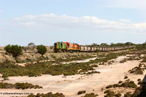 060109 2094
Kyancutta at the 198 km, ASR 830 class unit 842, an AE Goodwin built ALCo DL531 model loco serial 84140 leads EMD unit 1204 due to air-conditioning trouble and sister ALCo 851 across a dry salt soak with a north bound empty grain train. January 9, 2006.
Keywords: 830-class;842;AE-Goodwin;ALCo;DL531;84140;