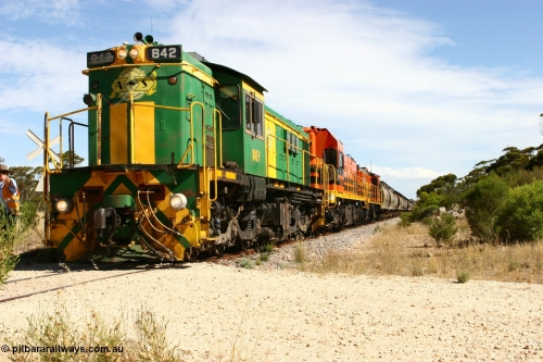 060109 2102
Kyancutta, Kyancutta Tanks Rd grade crossing, ASR 830 class unit 842, an AE Goodwin built ALCo DL531 model loco serial 84140 leads EMD unit 1204 due to air-conditioning trouble and sister ALCo 851 as the empty north bound grain train pauses for a crew change. January 9, 2006.
Keywords: 830-class;842;AE-Goodwin;ALCo;DL531;84140;