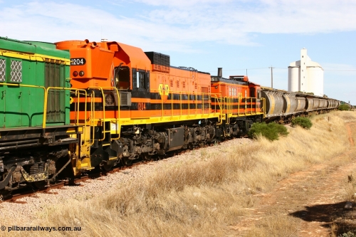 060109 2116
Kyancutta, ARG's Clyde Engineering built EMD G12C 1200 class unit 1204 serial 65-428 was originally built for the WAGR as their A class unit A 1514. Due to air-conditioning trouble it is in the shafts as they shunt across Museum Terrace to place empty grain waggons on the silo loop. January 9, 2006.
Keywords: 1200-class;1204;Clyde-Engineering-Granville-NSW;EMD;G12C;65-428;A-class;A1514;