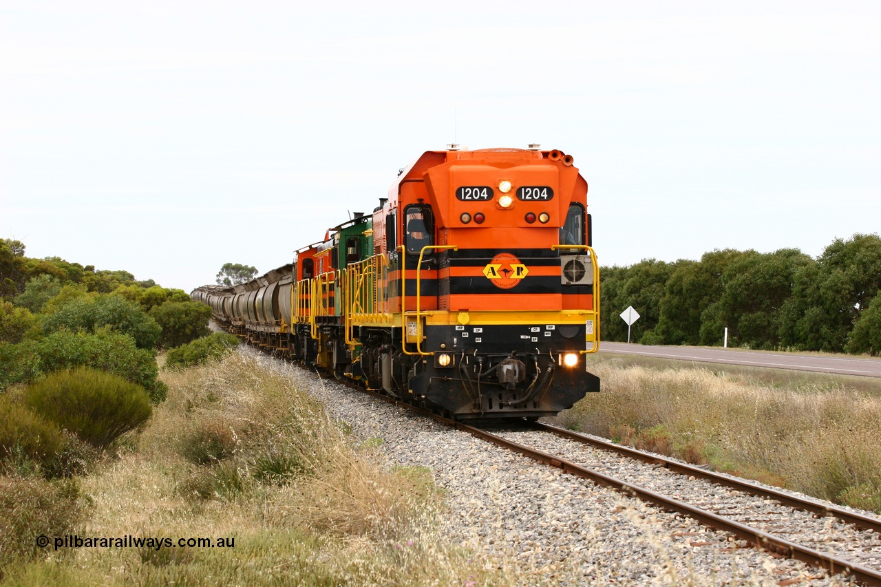 060110 2180
Near the 73 km and Cockaleechie Road grade crossing, empty grain train with ARG 1200 class unit 1204, a Clyde Engineering EMD model G12C serial 65-428, originally built for the WAGR as the final unit of fourteen A class locomotives in 1965 and sent to the Eyre Peninsula in July 2004 and two 830 class AE Goodwin built ALCo model DL531 units 842 serial 84140 ex SAR broad gauge to Eyre Peninsula in October 1987, and 851 serial 84137 new to Eyre Peninsula in 1962. [url=https://goo.gl/maps/LoznGHgHTUC2]Approx. location of image[/url].
Keywords: 1200-class;1204;Clyde-Engineering-Granville-NSW;EMD;G12C;65-428;A-class;A1514;830-class;842;851;AE-Goodwin;ALCo;DL531;84137;84140;