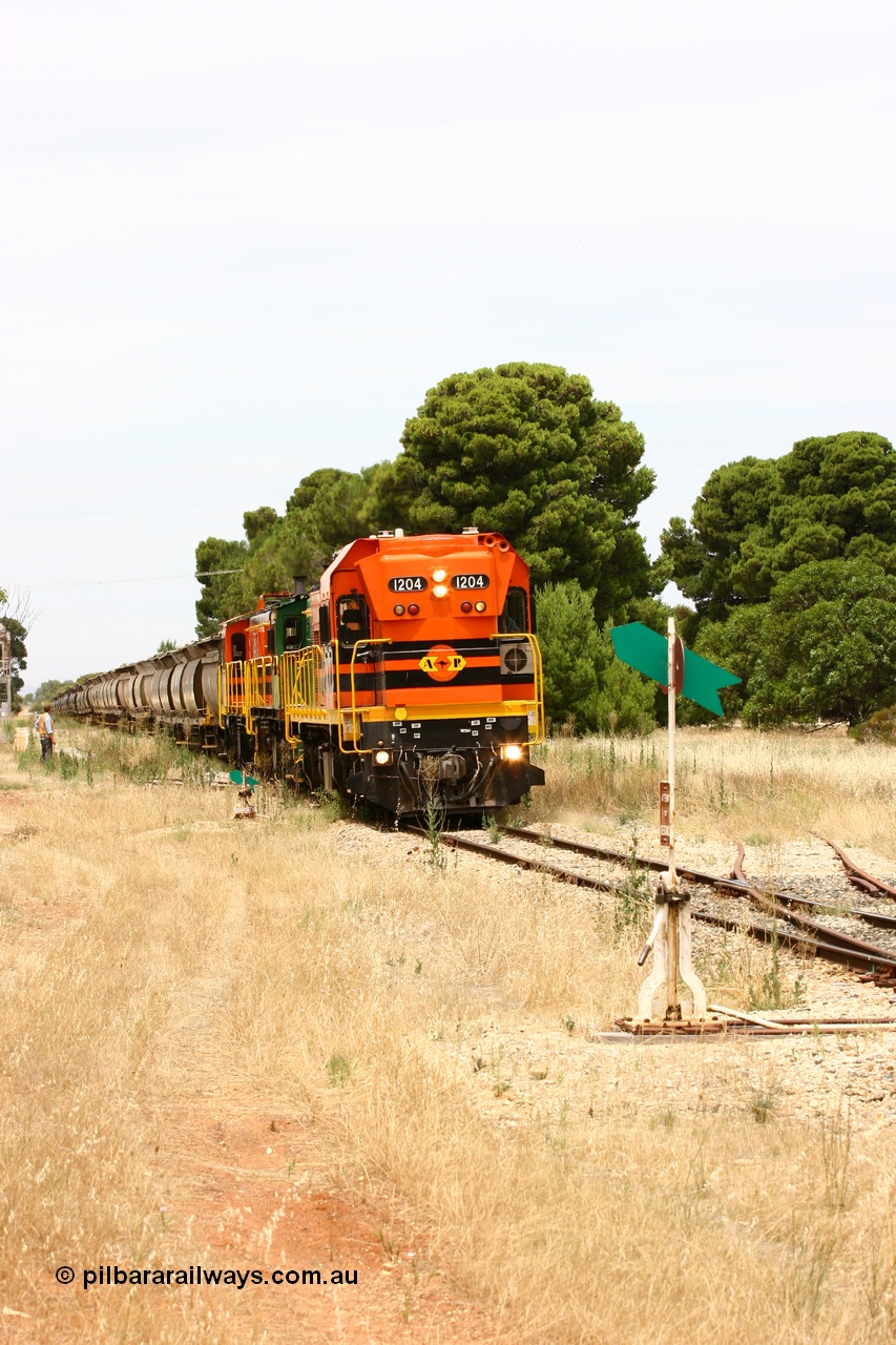 060110 2191
Yeelanna, the second person watches ARG 1200 class unit 1204, a Clyde Engineering EMD model G12C serial 65-428, originally built for the WAGR as the final unit of fourteen A class locomotives in 1965 and sent to the Eyre Peninsula in July 2004 as it shunts forward to cut out the empty cars for the siding. [url=https://goo.gl/maps/1JetzWBTGAw]Approx. location of image[/url].
Keywords: 1200-class;1204;Clyde-Engineering-Granville-NSW;EMD;G12C;65-428;A-class;A1514;