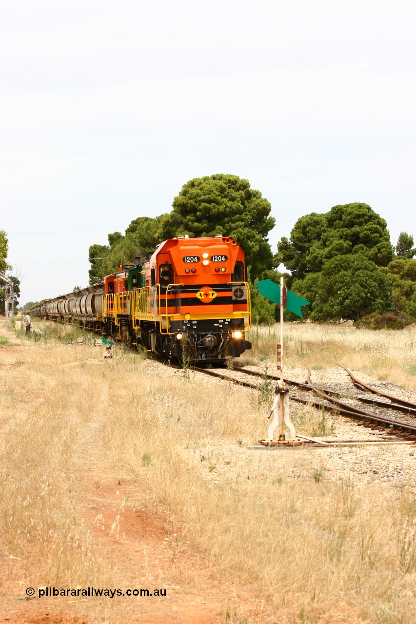 060110 2192
Yeelanna, the second person watches ARG 1200 class unit 1204, a Clyde Engineering EMD model G12C serial 65-428, originally built for the WAGR as the final unit of fourteen A class locomotives in 1965 and sent to the Eyre Peninsula in July 2004 as it shunts forward to cut out the empty cars for the siding. [url=https://goo.gl/maps/1JetzWBTGAw]Approx. location of image[/url].
Keywords: 1200-class;1204;Clyde-Engineering-Granville-NSW;EMD;G12C;65-428;A-class;A1514;