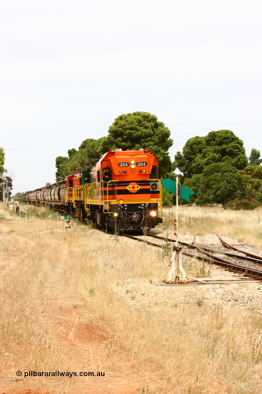 060110 2193
Yeelanna, the second person watches ARG 1200 class unit 1204, a Clyde Engineering EMD model G12C serial 65-428, originally built for the WAGR as the final unit of fourteen A class locomotives in 1965 and sent to the Eyre Peninsula in July 2004 as it shunts forward to cut out the empty cars for the siding. [url=https://goo.gl/maps/1JetzWBTGAw]Approx. location of image[/url].
Keywords: 1200-class;1204;Clyde-Engineering-Granville-NSW;EMD;G12C;65-428;A-class;A1514;