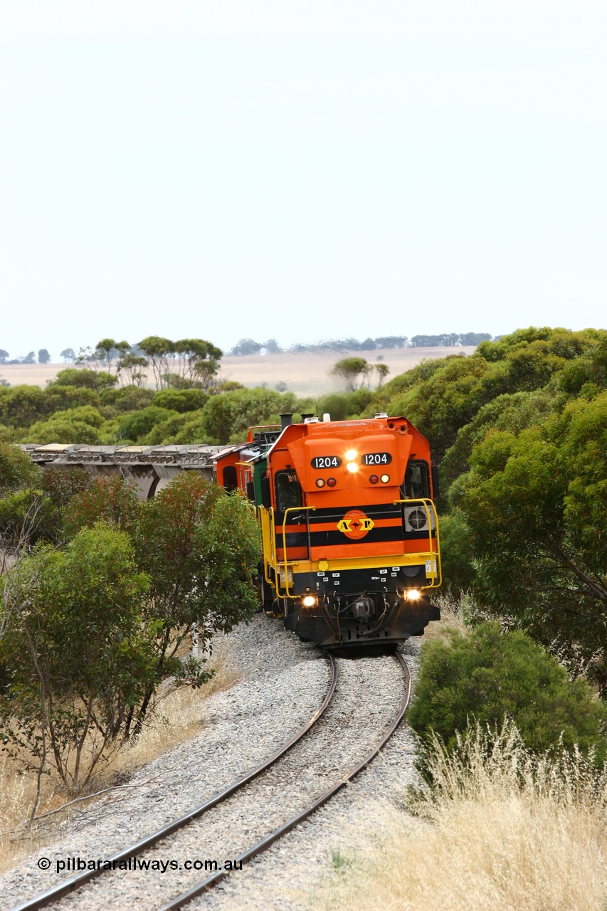 060110 2208
On the curve near the 85 km between Yeelanna and Karkoo, ARG 1200 class unit 1204, a Clyde Engineering EMD model G12C serial 65-428, originally built for the WAGR as the final unit of fourteen A class locomotives in 1965 and sent to the Eyre Peninsula in July 2004 leads an empty grain train. [url=https://goo.gl/maps/7kwfXBE6nS12]Approx. location of image[/url].
Keywords: 1200-class;1204;Clyde-Engineering-Granville-NSW;EMD;G12C;65-428;A-class;A1514;