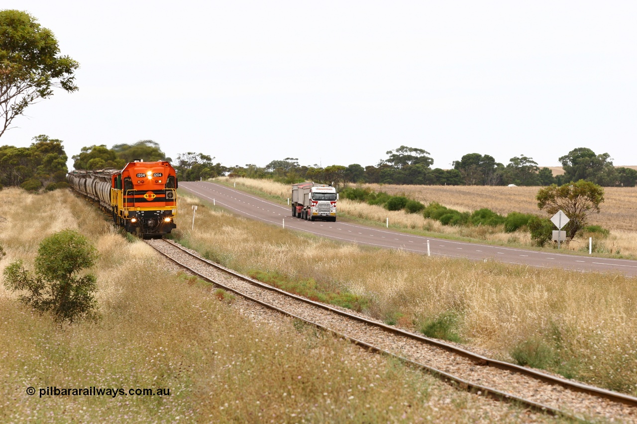 060110 2218
At the Procter Rd grade crossing about halfway between Yeelanna and Karkoo, empty grain train behind ARG 1200 class unit 1204, a Clyde Engineering EMD model G12C serial 65-428, originally built for the WAGR as the final unit of fourteen A class locomotives in 1965 and sent to the Eyre Peninsula in July 2004 and two 830 class AE Goodwin built ALCo model DL531 units with the road competition from a Llewelyn Transport road train with a Freightliner prime mover. [url=https://goo.gl/maps/DzBHRaUezTF2]Approx. location of image[/url].
Keywords: 1200-class;1204;Clyde-Engineering-Granville-NSW;EMD;G12C;65-428;A-class;A1514;