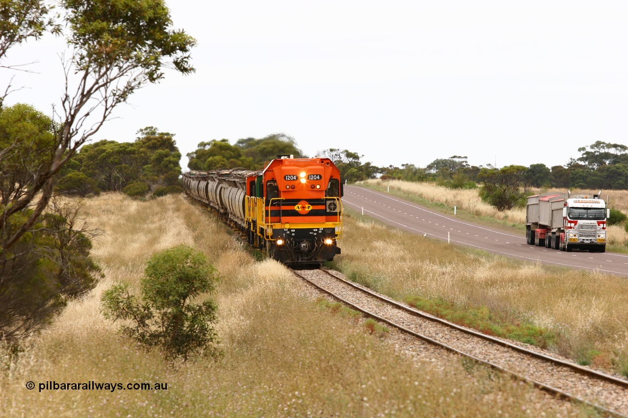 060110 2219
At the Procter Rd grade crossing about halfway between Yeelanna and Karkoo, empty grain train behind ARG 1200 class unit 1204, a Clyde Engineering EMD model G12C serial 65-428, originally built for the WAGR as the final unit of fourteen A class locomotives in 1965 and sent to the Eyre Peninsula in July 2004 and two 830 class AE Goodwin built ALCo model DL531 units with the road competition from a Llewelyn Transport road train with a Freightliner prime mover. [url=https://goo.gl/maps/DzBHRaUezTF2]Approx. location of image[/url].
Keywords: 1200-class;1204;Clyde-Engineering-Granville-NSW;EMD;G12C;65-428;A-class;A1514;