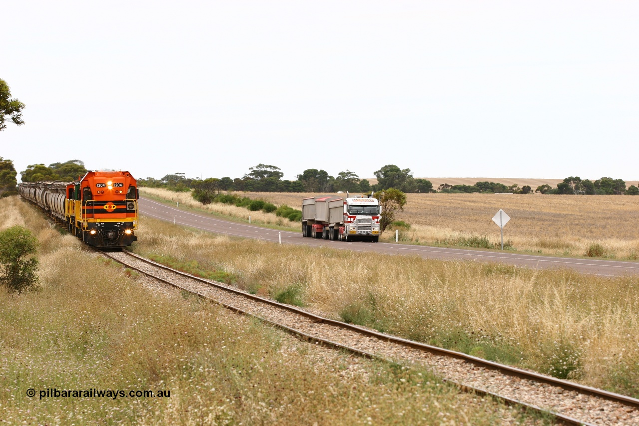 060110 2220
At the Procter Rd grade crossing about halfway between Yeelanna and Karkoo, empty grain train behind ARG 1200 class unit 1204, a Clyde Engineering EMD model G12C serial 65-428, originally built for the WAGR as the final unit of fourteen A class locomotives in 1965 and sent to the Eyre Peninsula in July 2004 and two 830 class AE Goodwin built ALCo model DL531 units with the road competition from a Llewelyn Transport road train with a Freightliner prime mover. [url=https://goo.gl/maps/DzBHRaUezTF2]Approx. location of image[/url].
Keywords: 1200-class;1204;Clyde-Engineering-Granville-NSW;EMD;G12C;65-428;A-class;A1514;