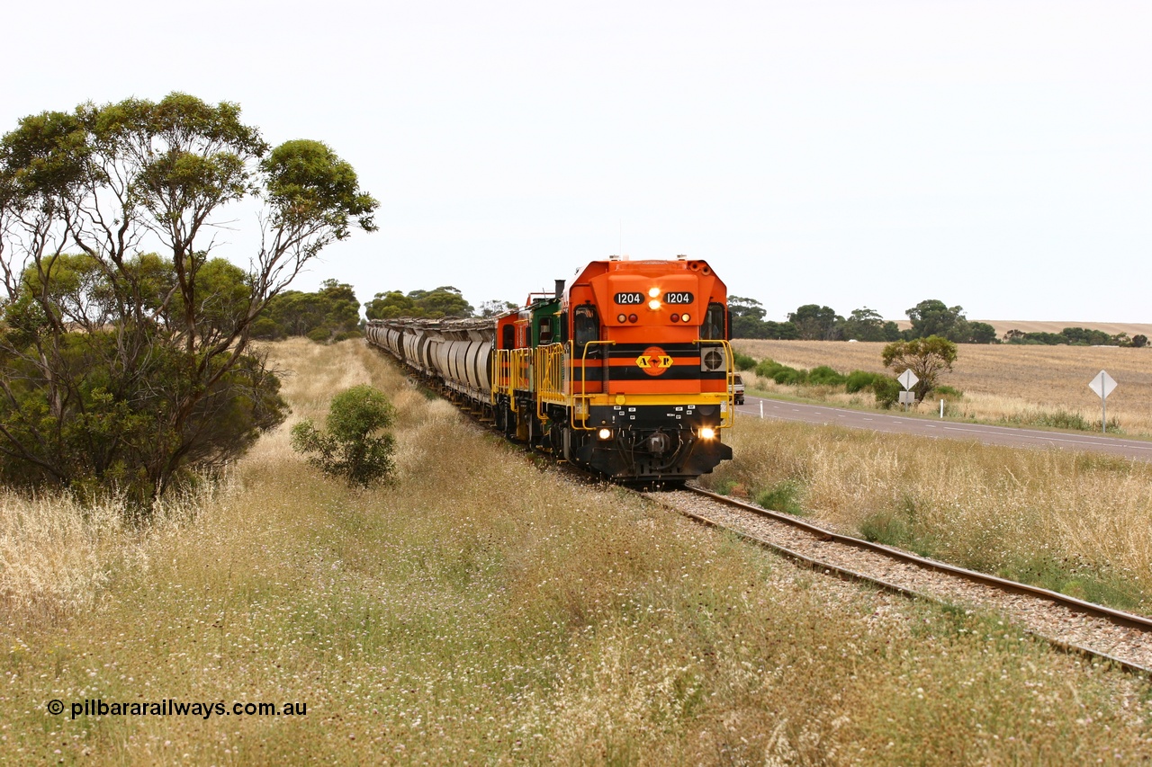 060110 2222
At the Procter Rd grade crossing about halfway between Yeelanna and Karkoo, empty grain train behind ARG 1200 class unit 1204, a Clyde Engineering EMD model G12C serial 65-428, originally built for the WAGR as the final unit of fourteen A class locomotives in 1965 and sent to the Eyre Peninsula in July 2004 and two 830 class AE Goodwin built ALCo model DL531 units 842 serial 84140 ex SAR broad gauge and to Eyre Peninsula in October 1987, and 851 serial 84137 new to Eyre Peninsula in 1962. [url=https://goo.gl/maps/DzBHRaUezTF2]Approx. location of image[/url].
Keywords: 1200-class;1204;Clyde-Engineering-Granville-NSW;EMD;G12C;65-428;A-class;A1514;