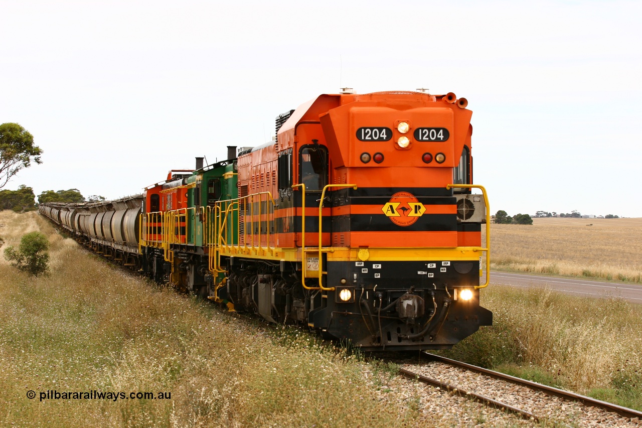 060110 2225
At the Procter Rd grade crossing about halfway between Yeelanna and Karkoo, empty grain train behind ARG 1200 class unit 1204, a Clyde Engineering EMD model G12C serial 65-428, originally built for the WAGR as the final unit of fourteen A class locomotives in 1965 and sent to the Eyre Peninsula in July 2004 and two 830 class AE Goodwin built ALCo model DL531 units 842 serial 84140 ex SAR broad gauge and to Eyre Peninsula in October 1987, and 851 serial 84137 new to Eyre Peninsula in 1962. [url=https://goo.gl/maps/DzBHRaUezTF2]Approx. location of image[/url].
Keywords: 1200-class;1204;Clyde-Engineering-Granville-NSW;EMD;G12C;65-428;A-class;A1514;830-class;842;851;AE-Goodwin;ALCo;DL531;84137;84140;