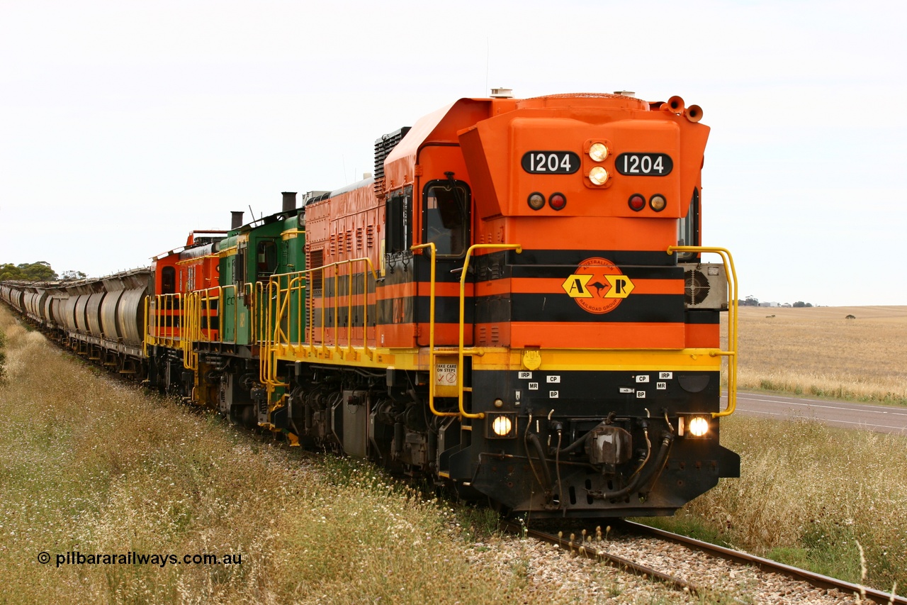 060110 2226
At the Procter Rd grade crossing about halfway between Yeelanna and Karkoo, empty grain train behind ARG 1200 class unit 1204, a Clyde Engineering EMD model G12C serial 65-428, originally built for the WAGR as the final unit of fourteen A class locomotives in 1965 and sent to the Eyre Peninsula in July 2004 and two 830 class AE Goodwin built ALCo model DL531 units 842 serial 84140 ex SAR broad gauge and to Eyre Peninsula in October 1987, and 851 serial 84137 new to Eyre Peninsula in 1962. [url=https://goo.gl/maps/DzBHRaUezTF2]Approx. location of image[/url].
Keywords: 1200-class;1204;Clyde-Engineering-Granville-NSW;EMD;G12C;65-428;A-class;A1514;