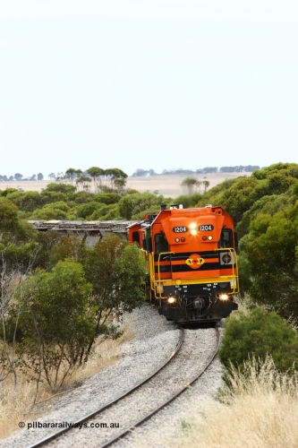 060110 2209
On the curve near the 85 km between Yeelanna and Karkoo, ARG 1200 class unit 1204, a Clyde Engineering EMD model G12C serial 65-428, originally built for the WAGR as the final unit of fourteen A class locomotives in 1965 and sent to the Eyre Peninsula in July 2004 leads an empty grain train. [url=https://goo.gl/maps/7kwfXBE6nS12]Approx. location of image[/url].
Keywords: 1200-class;1204;Clyde-Engineering-Granville-NSW;EMD;G12C;65-428;A-class;A1514;