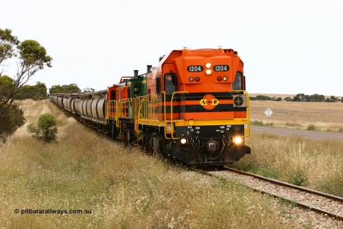 060110 2224
At the Procter Rd grade crossing about halfway between Yeelanna and Karkoo, empty grain train behind ARG 1200 class unit 1204, a Clyde Engineering EMD model G12C serial 65-428, originally built for the WAGR as the final unit of fourteen A class locomotives in 1965 and sent to the Eyre Peninsula in July 2004 and two 830 class AE Goodwin built ALCo model DL531 units 842 serial 84140 ex SAR broad gauge and to Eyre Peninsula in October 1987, and 851 serial 84137 new to Eyre Peninsula in 1962. [url=https://goo.gl/maps/DzBHRaUezTF2]Approx. location of image[/url].
Keywords: 1200-class;1204;Clyde-Engineering-Granville-NSW;EMD;G12C;65-428;A-class;A1514;