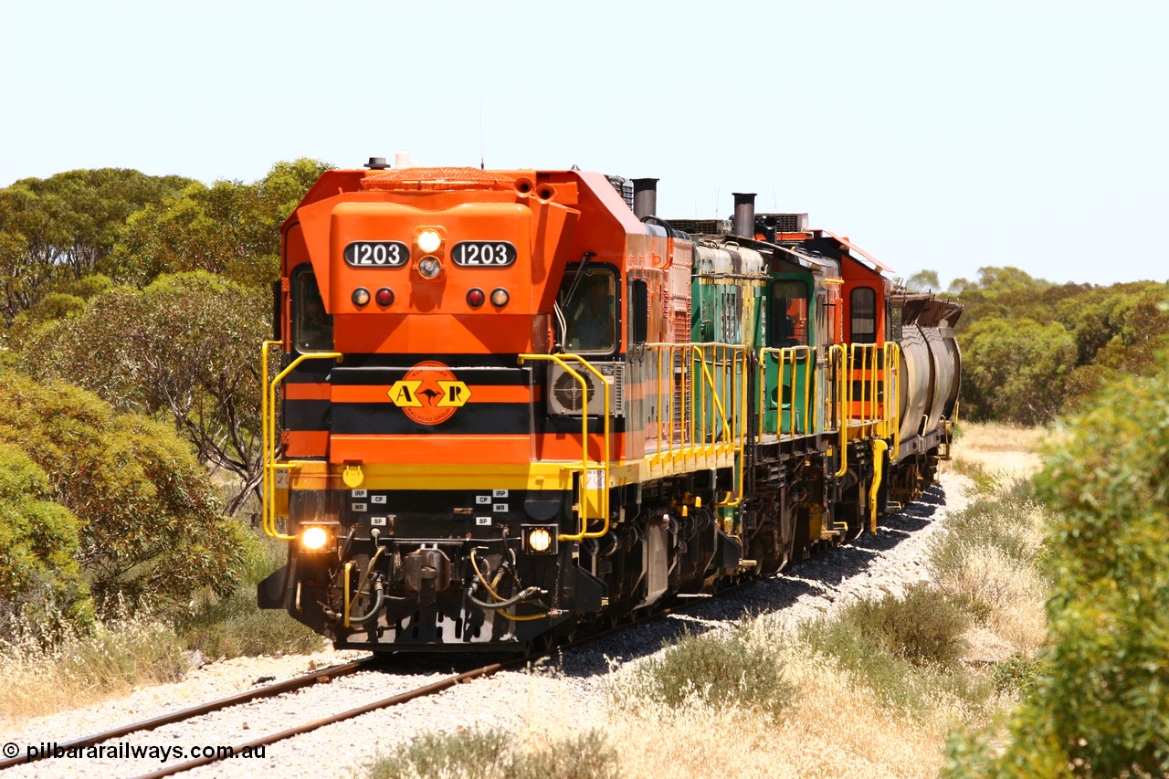 060111 2246
Tooligie, Mac's Road grade crossing at the 110 km, ARG 1200 class unit 1203, a Clyde Engineering EMD model G12C serial 65-427, one of fourteen originally built between 1960-65 for WAGR as their A class A 1513, fitted with dynamic brakes and financed by Western Mining Corporation, started working on the Eyre Peninsula in November 2004 leads an empty grain train north. 11th January 2006.
Keywords: 1200-class;1203;Clyde-Engineering-Granville-NSW;EMD;G12C;65-427;A-class;A1513;