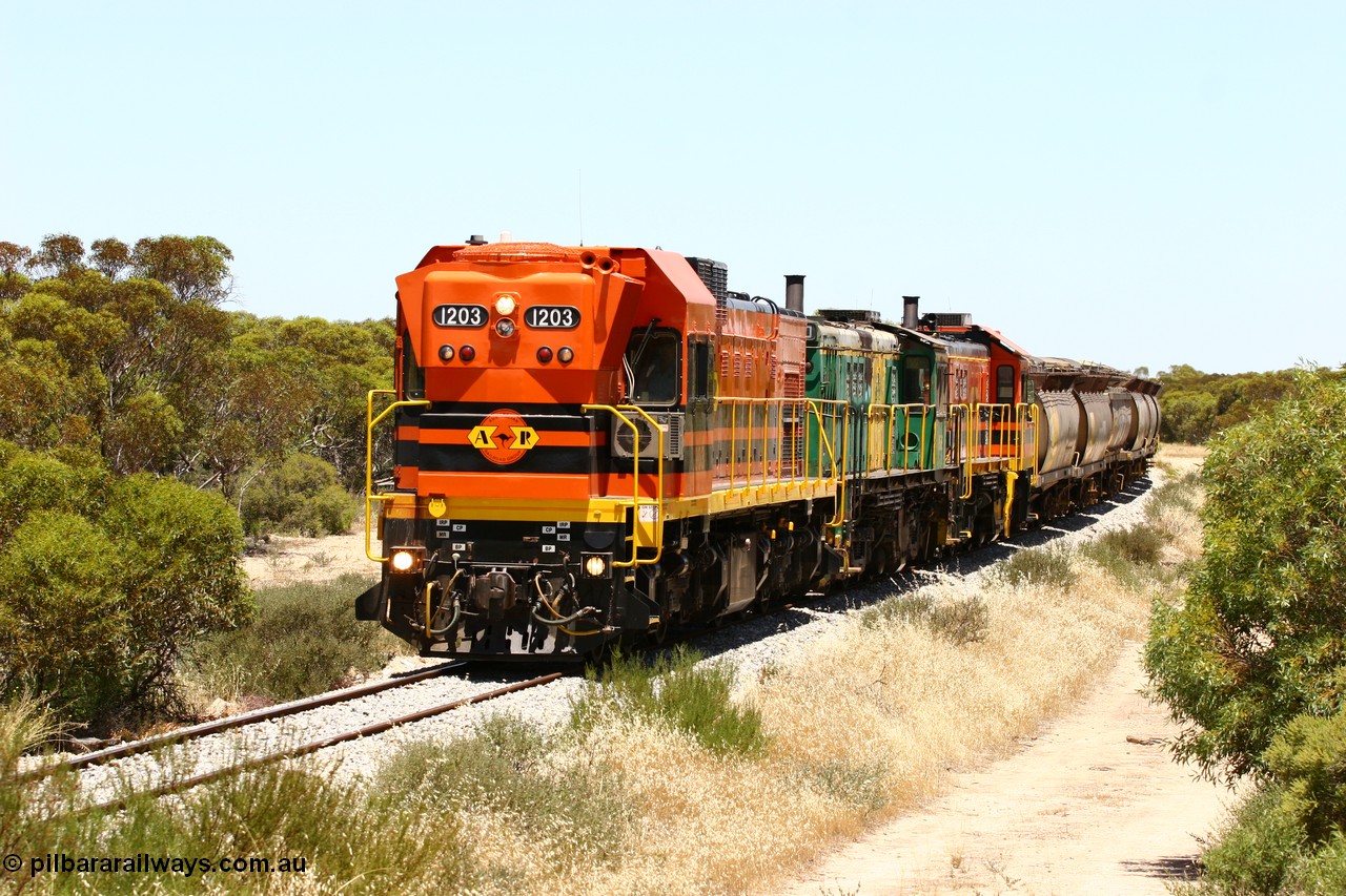 060111 2248
Tooligie, Mac's Road grade crossing at the 110 km, ARG 1200 class unit 1203, a Clyde Engineering EMD model G12C serial 65-427, one of fourteen originally built between 1960-65 for WAGR as their A class A 1513, fitted with dynamic brakes and financed by Western Mining Corporation, started working on the Eyre Peninsula in November 2004 leads an empty grain train north. 11th January 2006.
Keywords: 1200-class;1203;Clyde-Engineering-Granville-NSW;EMD;G12C;65-427;A-class;A1513;