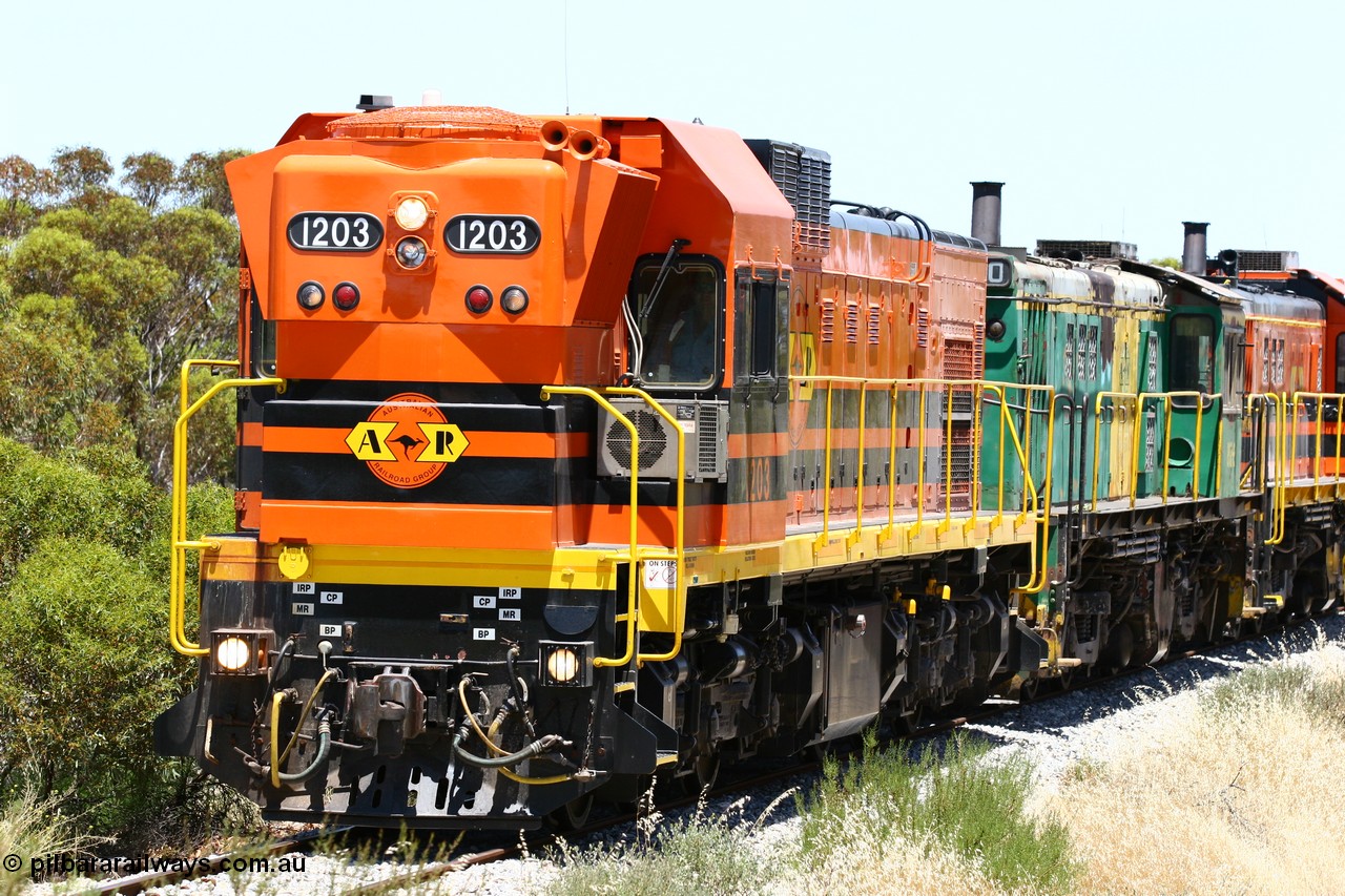 060111 2249
Tooligie, Mac's Road grade crossing at the 110 km, ARG 1200 class unit 1203, a Clyde Engineering EMD model G12C serial 65-427, one of fourteen originally built between 1960-65 for WAGR as their A class A 1513, fitted with dynamic brakes and financed by Western Mining Corporation, started working on the Eyre Peninsula in November 2004 leads an empty grain train north. 11th January 2006.
Keywords: 1200-class;1203;Clyde-Engineering-Granville-NSW;EMD;G12C;65-427;A-class;A1513;