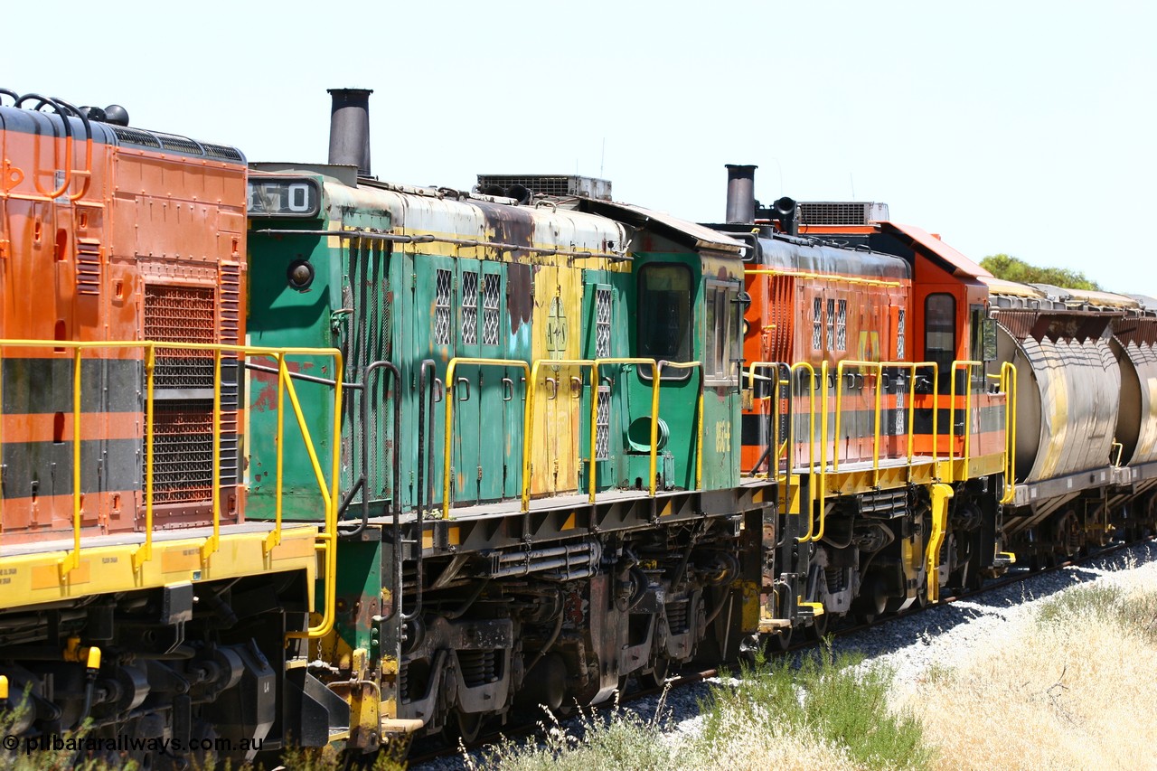 060111 2250
Tooligie, Mac's Road grade crossing at the 110 km, ARG 1200 class unit 1203, a Clyde Engineering EMD model G12C serial 65-427, one of fourteen originally built between 1960-65 for WAGR as their A class A 1513, fitted with dynamic brakes and financed by Western Mining Corporation, started working on the Eyre Peninsula in November 2004 leads an empty grain train north. 11th January 2006.
