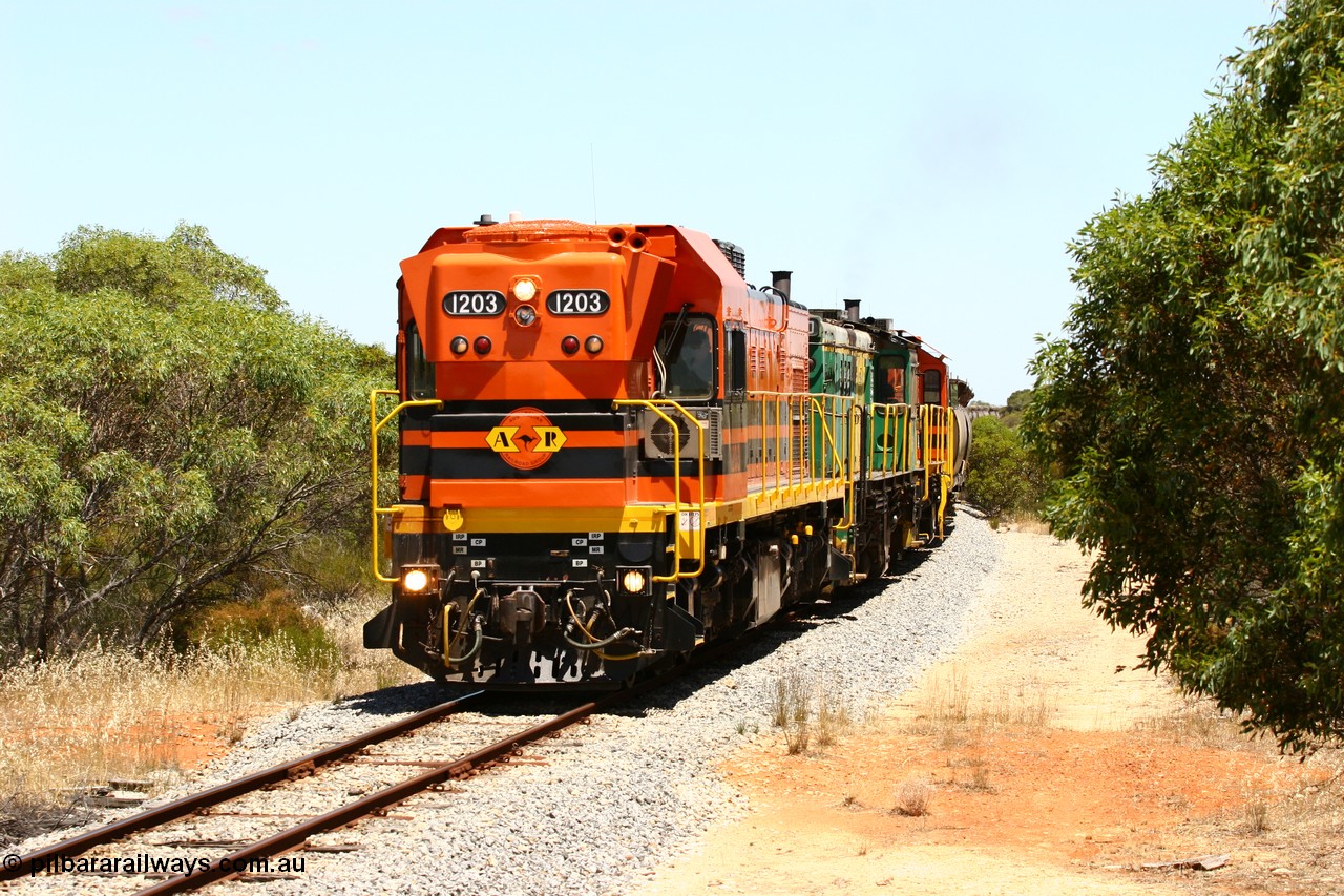 060111 2269
Tooligie, empty grain train running north behind ARG 1200 class unit 1203, a Clyde Engineering EMD model G12C serial 65-427, one of fourteen originally built between 1960-65 for WAGR as their A class A 1513, fitted with dynamic brakes and financed by Western Mining Corporation, started working on the Eyre Peninsula in November 2004. 11th January 2006.
Keywords: 1200-class;1203;Clyde-Engineering-Granville-NSW;EMD;G12C;65-427;A-class;A1513;