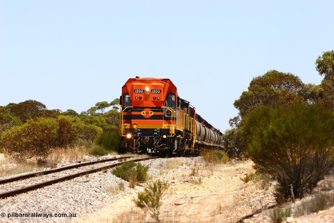 060111 2272
Peachna, Tooligie Hill Road grade crossing, empty grain train running north behind ARG 1200 class unit 1203, a Clyde Engineering EMD model G12C serial 65-427, one of fourteen originally built between 1960-65 for WAGR as their A class A 1513, fitted with dynamic brakes and financed by Western Mining Corporation, started working on the Eyre Peninsula in November 2004. 11th January 2006.
Keywords: 1200-class;1203;Clyde-Engineering-Granville-NSW;EMD;G12C;65-427;A-class;A1513;