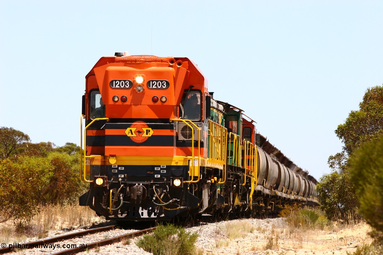 060111 2273
Peachna, Tooligie Hill Road grade crossing, empty grain train running north behind ARG 1200 class unit 1203, a Clyde Engineering EMD model G12C serial 65-427, one of fourteen originally built between 1960-65 for WAGR as their A class A 1513, fitted with dynamic brakes and financed by Western Mining Corporation, started working on the Eyre Peninsula in November 2004. 11th January 2006.
Keywords: 1200-class;1203;Clyde-Engineering-Granville-NSW;EMD;G12C;65-427;A-class;A1513;