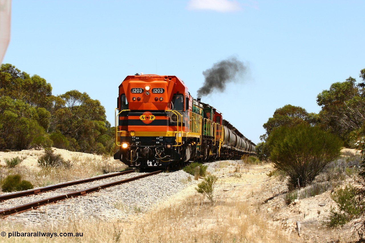 060111 2274
Peachna, Tooligie Hill Road grade crossing, empty grain train running north behind ARG 1200 class unit 1203, a Clyde Engineering EMD model G12C serial 65-427, one of fourteen originally built between 1960-65 for WAGR as their A class A 1513, fitted with dynamic brakes and financed by Western Mining Corporation, started working on the Eyre Peninsula in November 2004. 11th January 2006.
Keywords: 1200-class;1203;Clyde-Engineering-Granville-NSW;EMD;G12C;65-427;A-class;A1513;